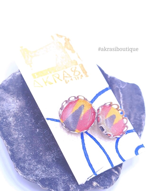 Round kente in yellow, red and black on silver stud earrings sealed in resin with filigree finish