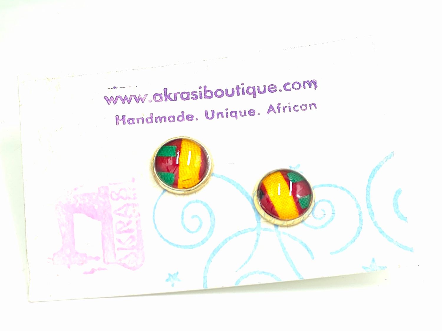 Round kente in yellow, red and green on silver stud earrings sealed in glass Round kente in yellow, red and green on silver stud earrings sealed in glass