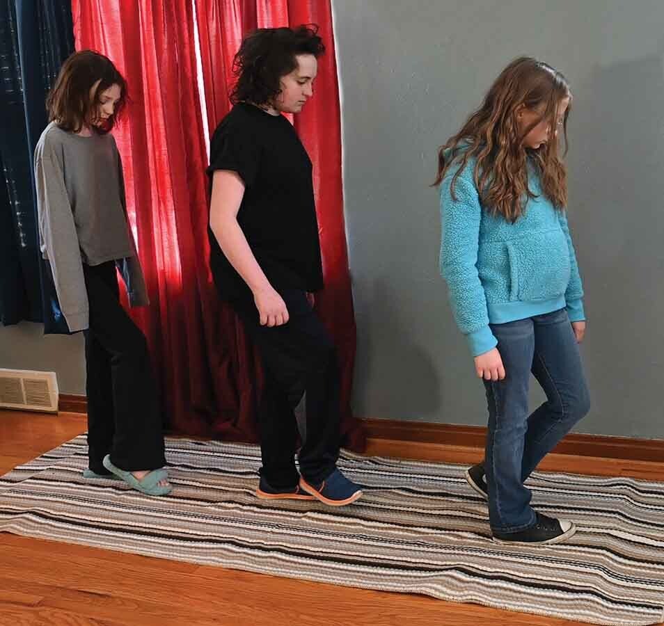 People walking across a squishy, soft floor designed for themed attractions. 