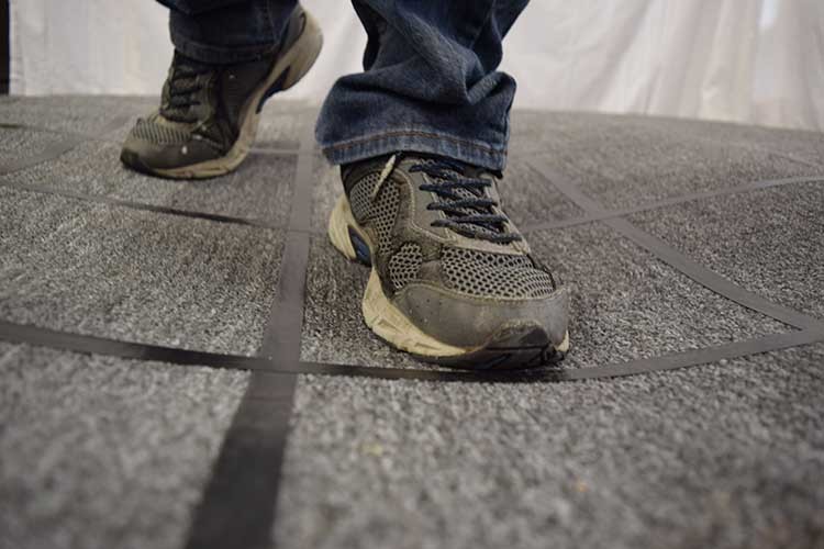 Someone walking across a squishy joke floor designed for use in theme park attractions. 