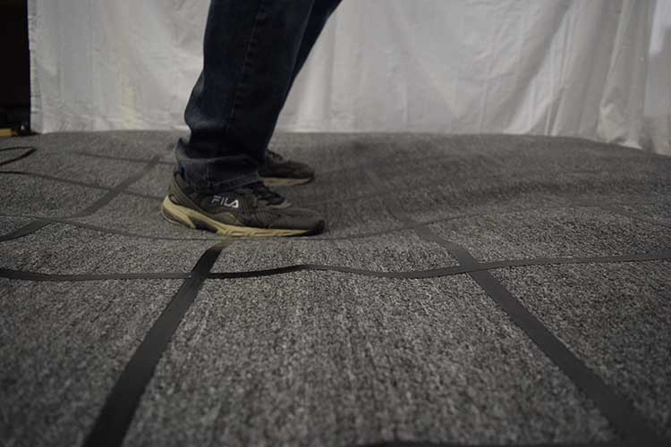 Someone stepping on a soft, pliable floor designed for fun attractions and experiences in theme parks and amusement centers. 