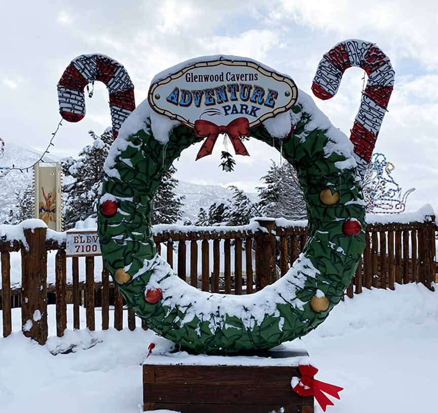 A snow-covered Christmas wreath photo opportunity prop at a theme park. 