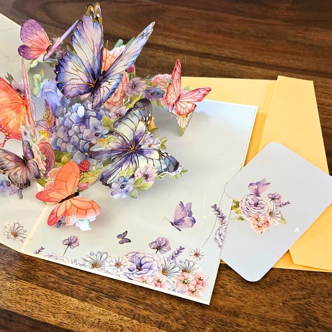 3D pop‑up cards that unfold into floral, butterfly, and whimsical enchanted‑scene designs.