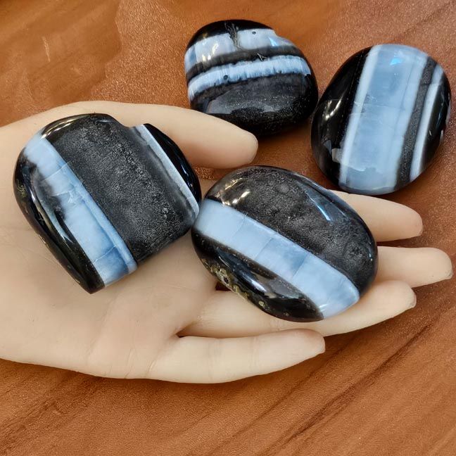 Large natural gemstone palm stones, smooth and luminous, for meditation and grounding.