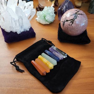Mini 1.5" gemstone chakra wands with double‑terminated points, seven stones, and a soft pouch for energy alignment.