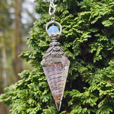 Opalite orgone pendulum with copper spiral, six‑sided design for intuition and clarity.