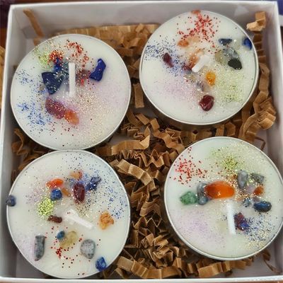 Chakra soy tea lights with lemon essential oil and colorful gemstone chips in a set of four.