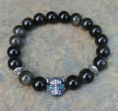 Obsidian bracelet with pavé panther bead and emerald green eyes, inspired by panther totem energy.