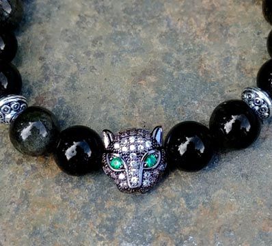 Obsidian bracelet with pavé panther bead and emerald green eyes, inspired by panther totem energy.