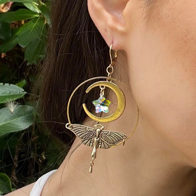 Luna Moth earrings with brass wings, crescent moons, and iridescent angel aura star crystals.