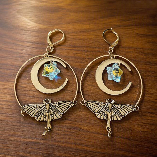 Luna Moth earrings with brass wings, crescent moons, and iridescent angel aura star crystals.