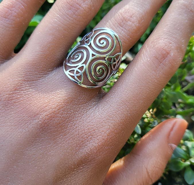Adjustable stainless steel ring engraved with the Celtic Triskele triple‑spiral symbol.