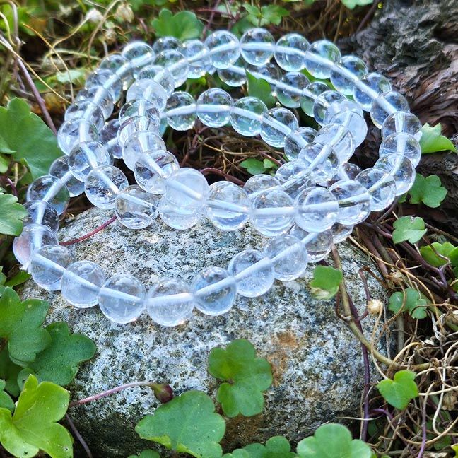 Clear Quartz bracelet with polished 8mm or 10mm beads symbolizing clarity, intention, and balance.