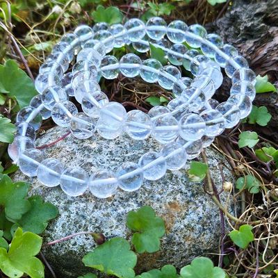Clear Quartz bracelet with polished 8mm or 10mm beads symbolizing clarity, intention, and balance.