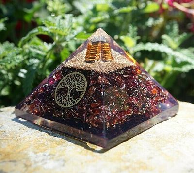 Garnet orgone pyramid with Tree of Life, clear quartz point, and copper spiral, 3-inch base.