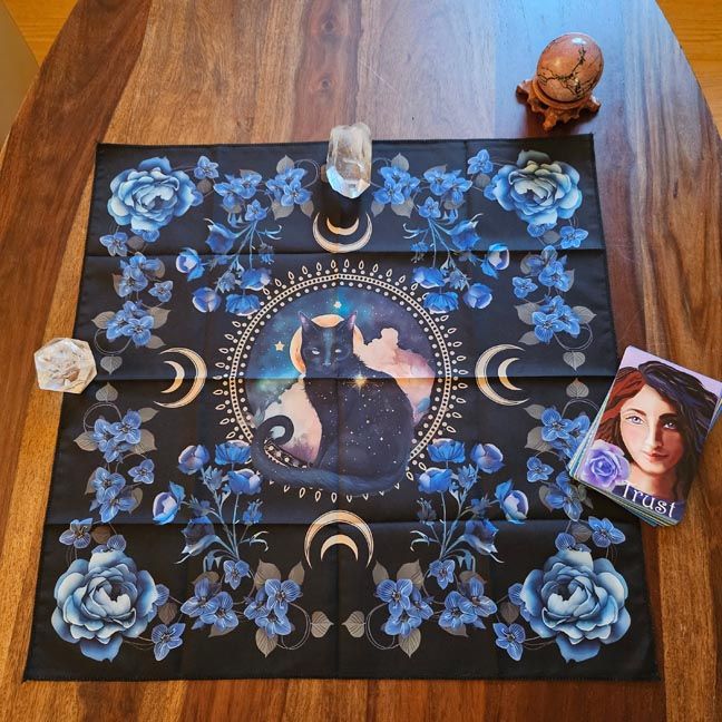 Black cat altar cloth with blue roses, crescent moons, and cosmic night sky, 18×18 polyester.