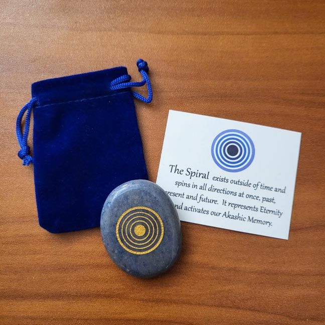 Blue aventurine palm stone with gold spiral design shown with a blue velvet pouch and a printed information card