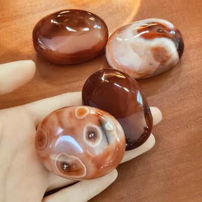 Large Carnelian palm stone, smooth 2" oval crystal for creativity, courage, vitality, and sacral chakra energy.