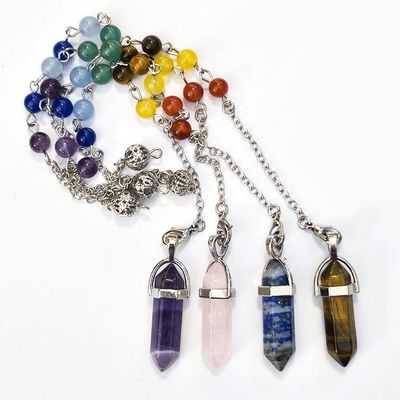 Celestial Flow gemstone pendulum with chakra chain, featuring hexagonal crystal point and healing stones.