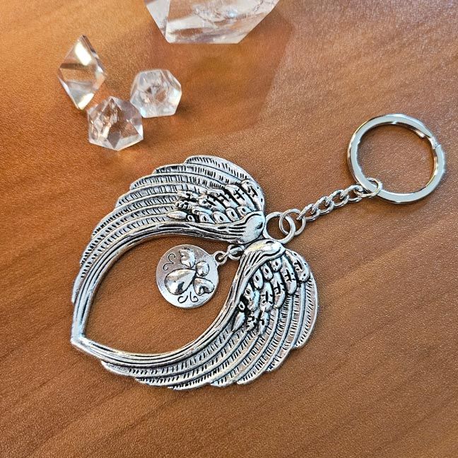 Angel wings key chain with tiny cherub charm symbolizing protection and comfort.