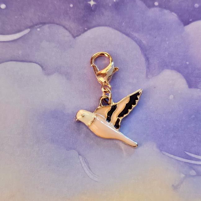 Pink enamel bird purse charm with soft roselight hues and an inspiring quote card.