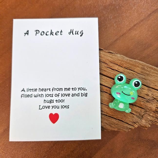 Whimsical green Frog Pocket Hug with soft color variations and a tiny inspiring note card.