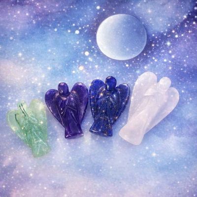 Four small crystal angels in green, purple, dark blue, and white arranged against a cosmic background with stars and moon