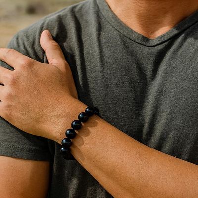 10mm Obsidian bracelet with smooth black volcanic glass beads for grounding and protection.