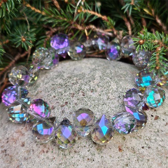 A faceted Austrian Crystal beads bracelet shimmering with purple, lavender, gold, and pink light.