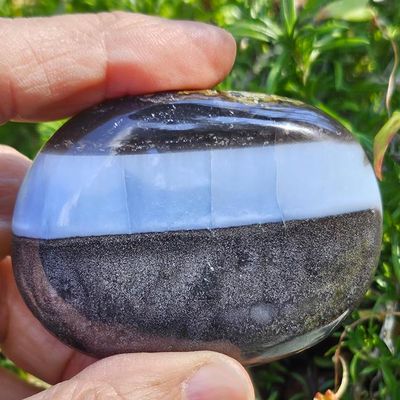 Natural Blue Opal 2" palm stone with soft blue hues for peace, emotional clarity, and gentle communication.