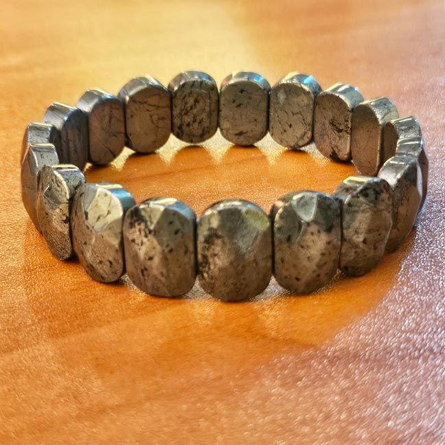 Golden pyrite bracelet with flat faceted slabs, shimmering with earthy gold tones for confidence and abundance.