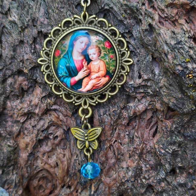 Bronze Madonna and Child pendant with butterfly charm and aqua bead.