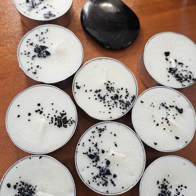 Shungite organic soy candle with Mint, Orange, Lavender, and Shungite stones for grounding and protection.
