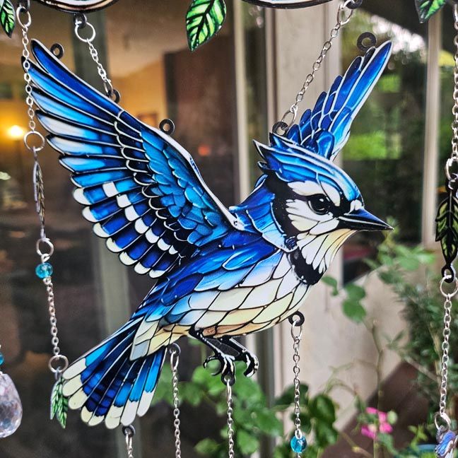 Blue Jay stained‑glass style suncatcher with prisms and double‑sided luminous blue artwork.