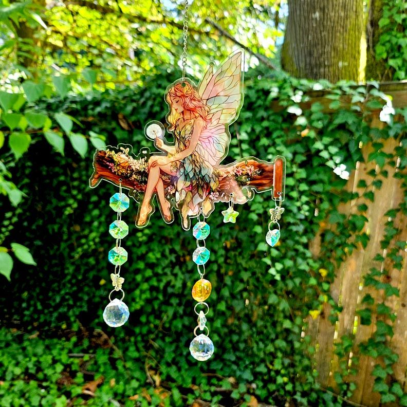 Fairy talisman suncatcher with rainbow prisms, silver butterflies, golden bead, and aura crystal hearts and stars.