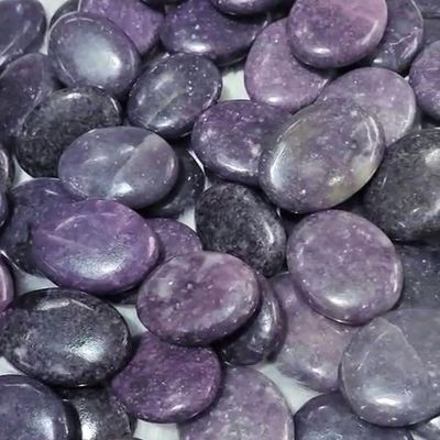 Smooth Lepidolite palm stone with lavender tones for calm and emotional balance.