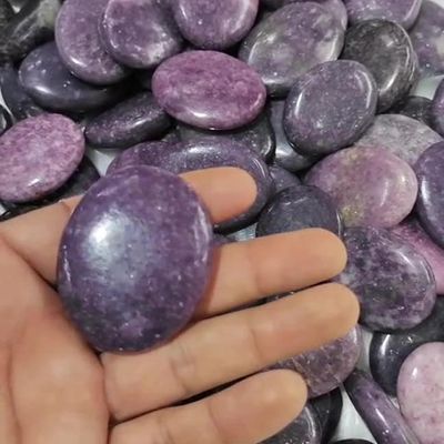 Smooth Lepidolite palm stone with lavender tones for calm and emotional balance.