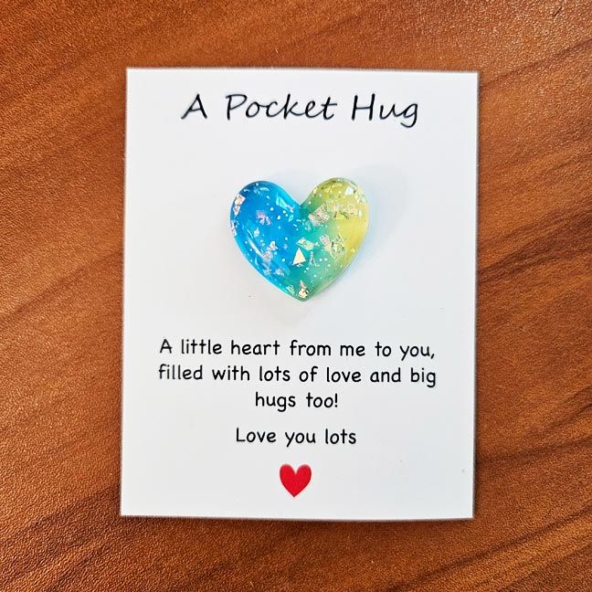Colorful resin Heart Pocket Hugs with tiny inspiring note cards for comfort and encouragement.