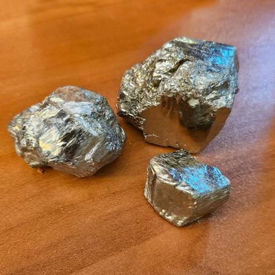 Raw pyrite crystal in three sizes for abundance, confidence, and protection.