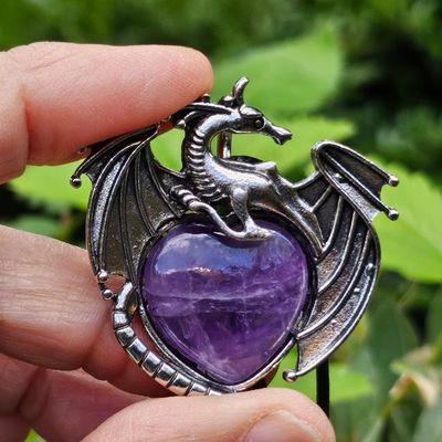 Silver dragon pendant with natural heart‑shaped gemstone and cotton cord.