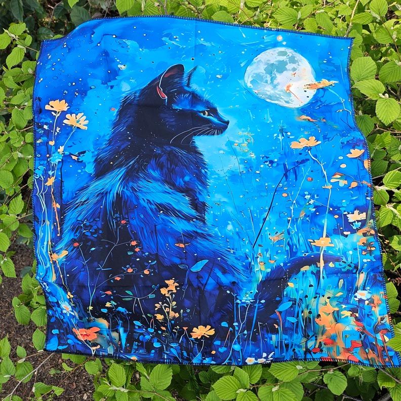 Black cat gazing at full moon amid blue wildflowers on mystical altar cloth.