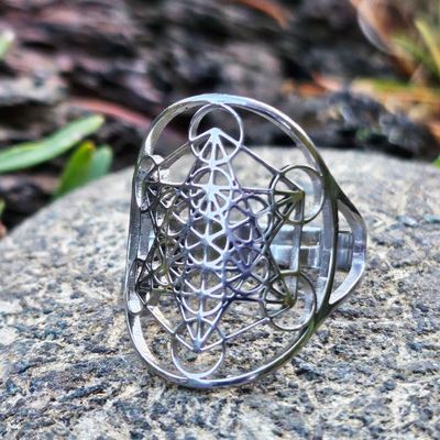 Adjustable stainless steel ring engraved with Metatron’s Cube sacred geometry symbol.