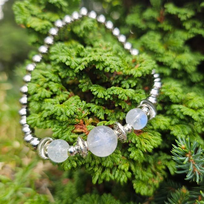 Rainbow Moonstone bracelet with crescent moon beads and stainless steel accents.