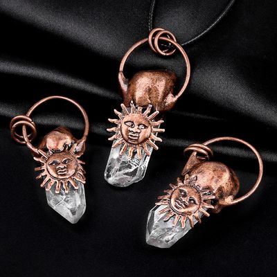 Copper sun pendant with clear quartz point on waxed cotton cord