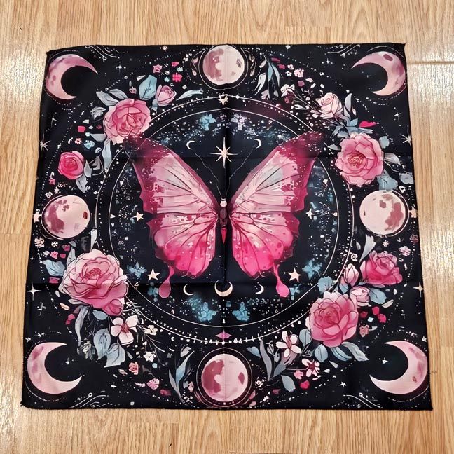 Pink butterfly altar cloth with roses, stars, full moons, and crescent moons on a dark celestial background.