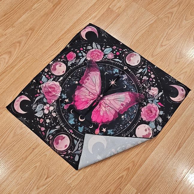 Pink butterfly altar cloth with roses, stars, full moons, and crescent moons on a dark celestial background.