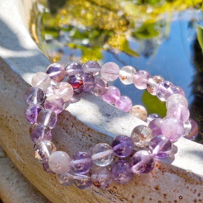 Violet Fire Quartz bracelet with pale amethyst, clear quartz, smoky quartz, and glowing hematite inclusions.