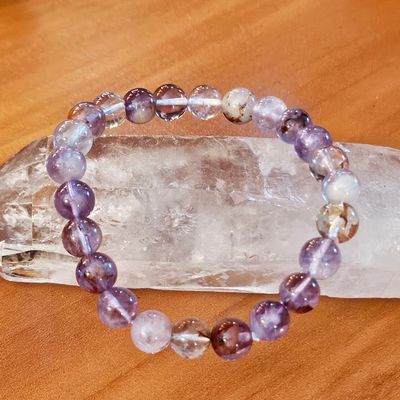 Violet Fire Quartz bracelet with pale amethyst, clear quartz, smoky quartz, and glowing hematite inclusions.