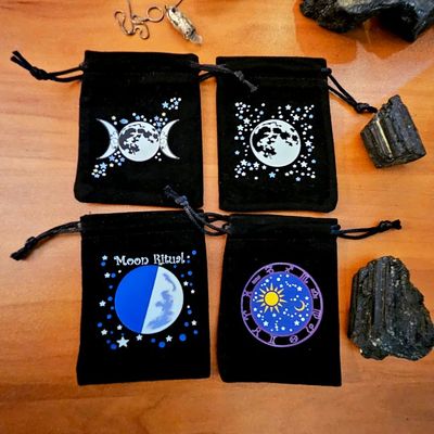 Soft velveteen pouch with moons and stars printed in vibrant celestial artwork.
