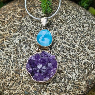 Handmade sterling silver pendant with a 1/2" Larimar cabochon and round 3/4" Amethyst cluster on an 18" chain.